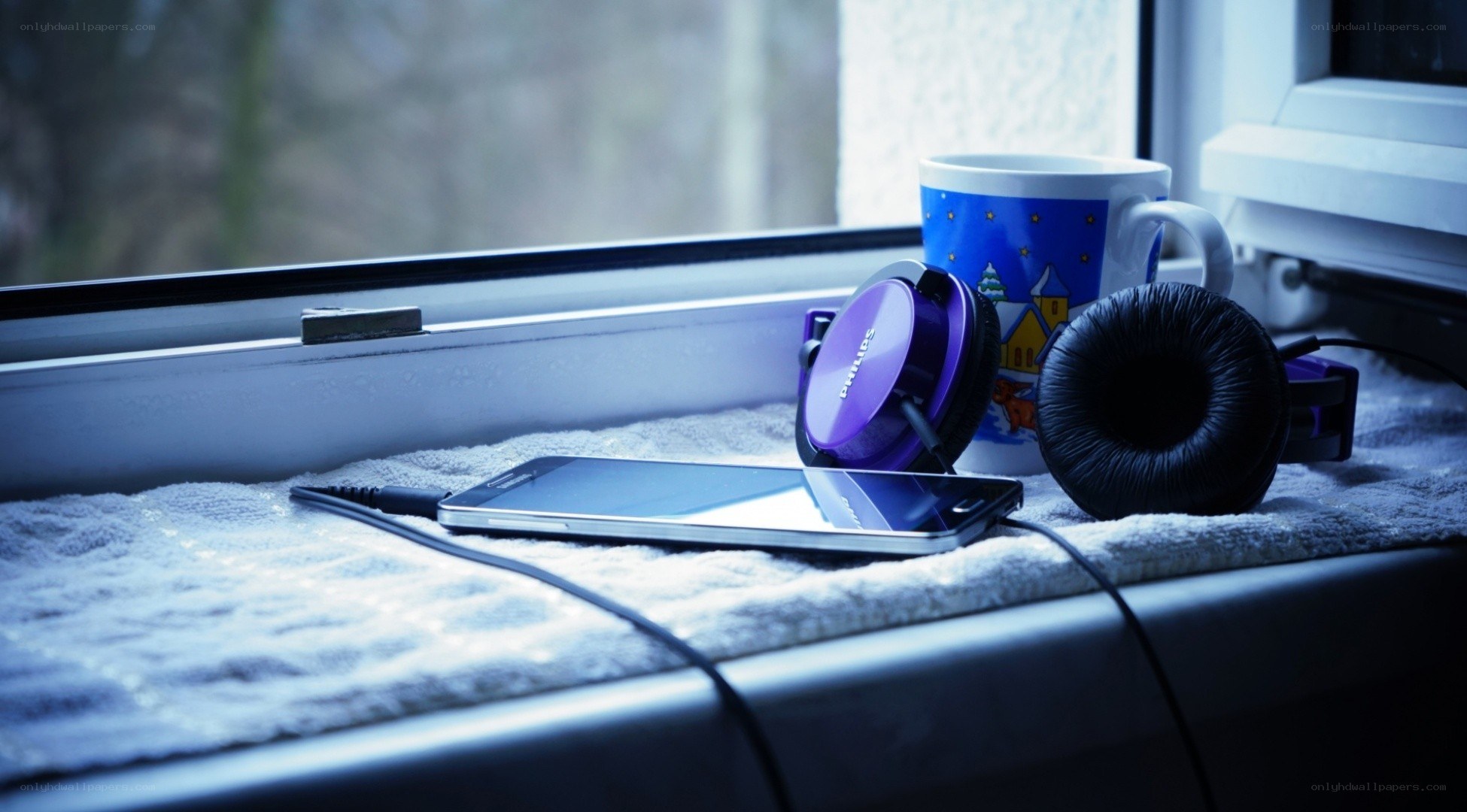 Headphones and phone on windowsill