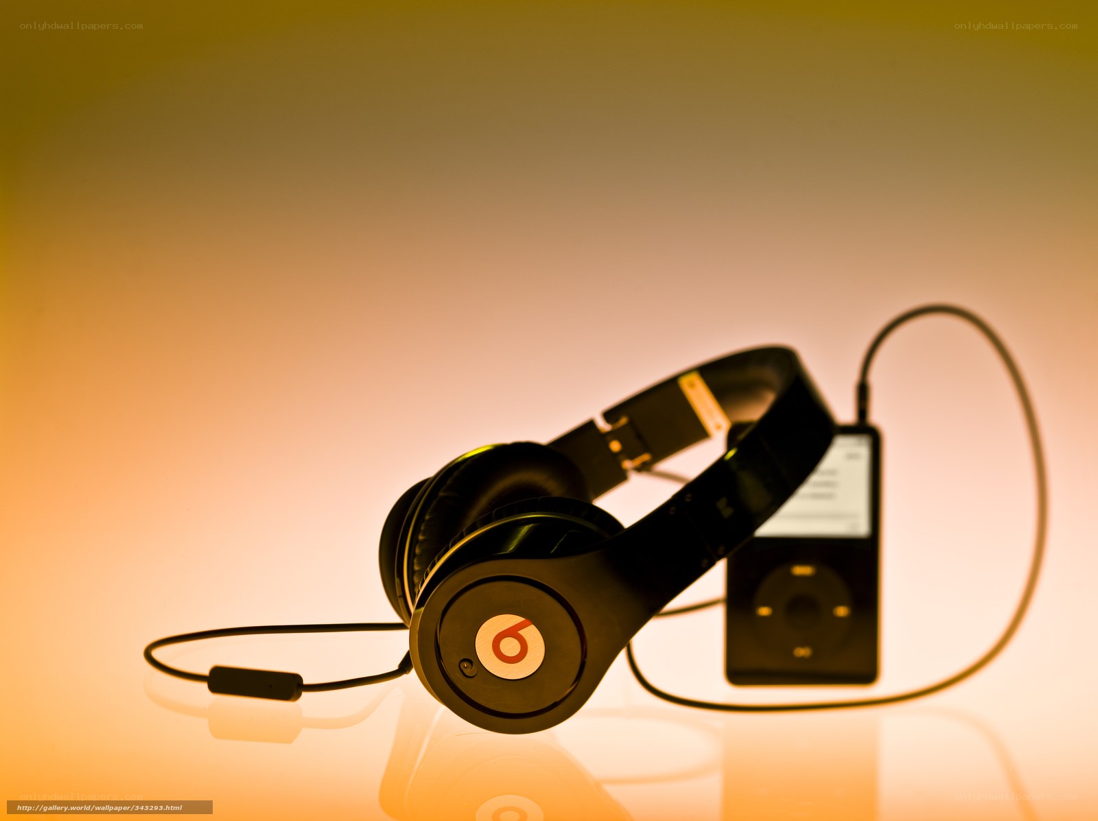 Headphones with iPod on warm background