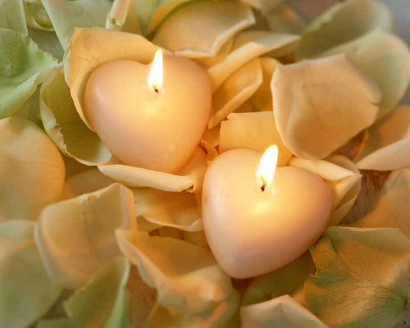 heart candles on rose petals
