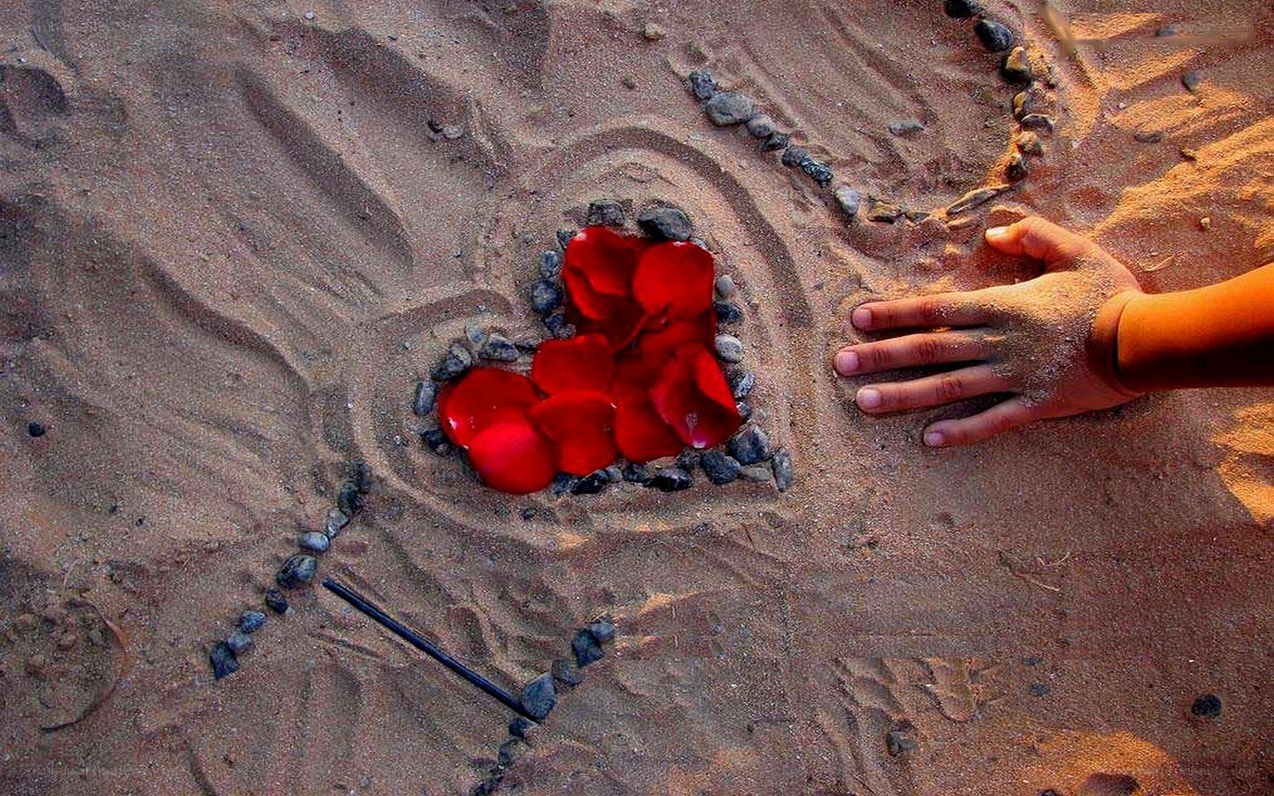 heart drawn in sand