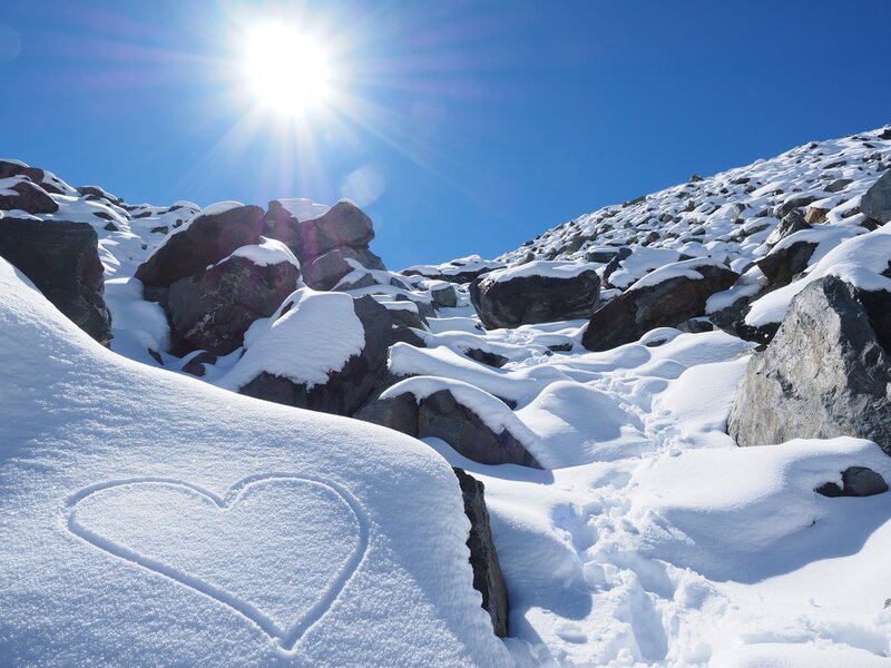 Heart drawn in snowy mountain
