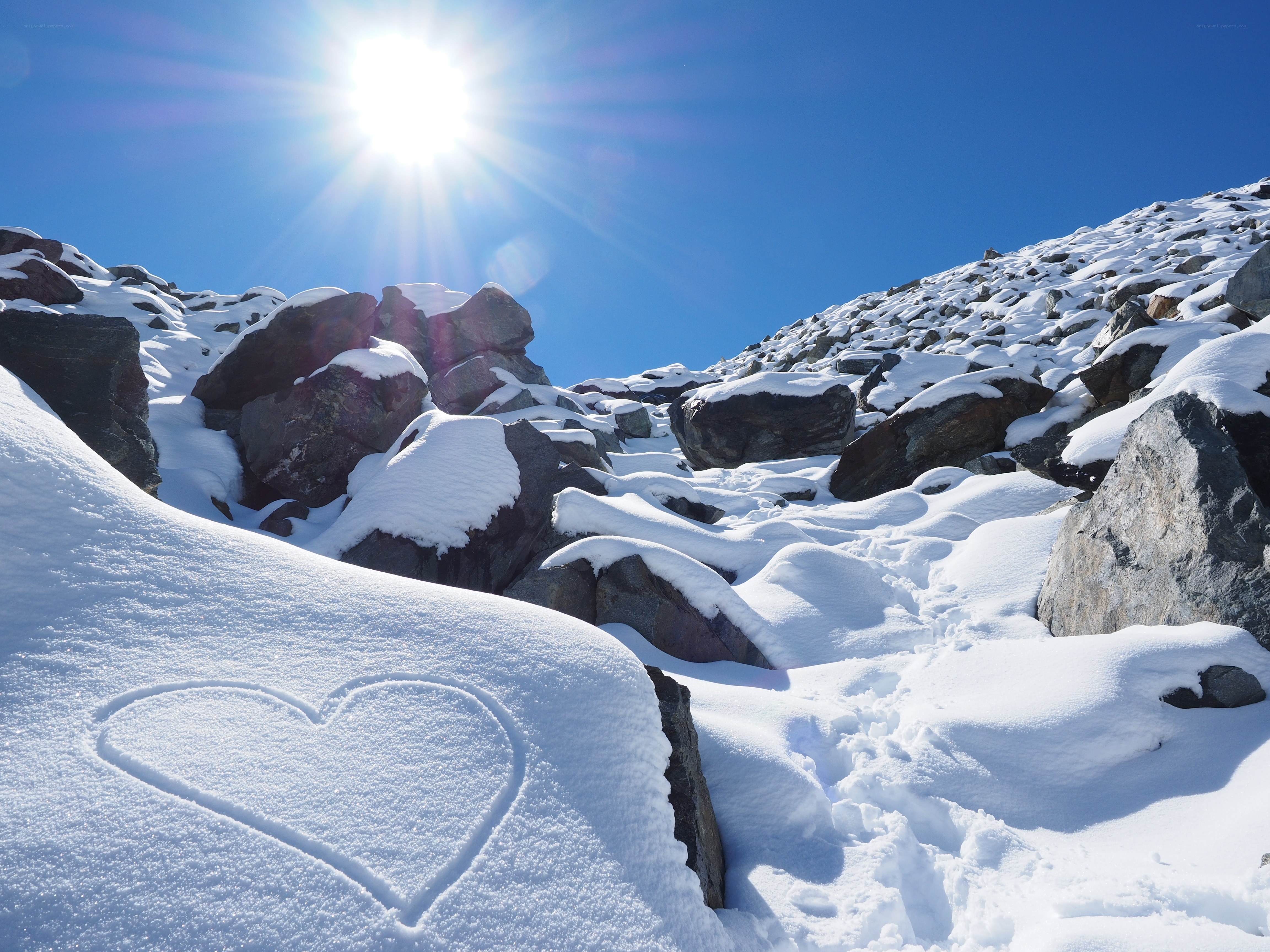 Heart drawn in snowy mountain