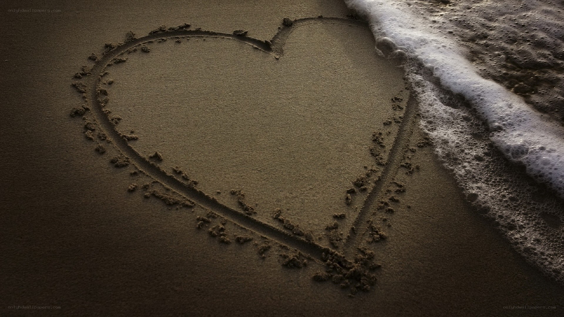 heart drawn in the sand
