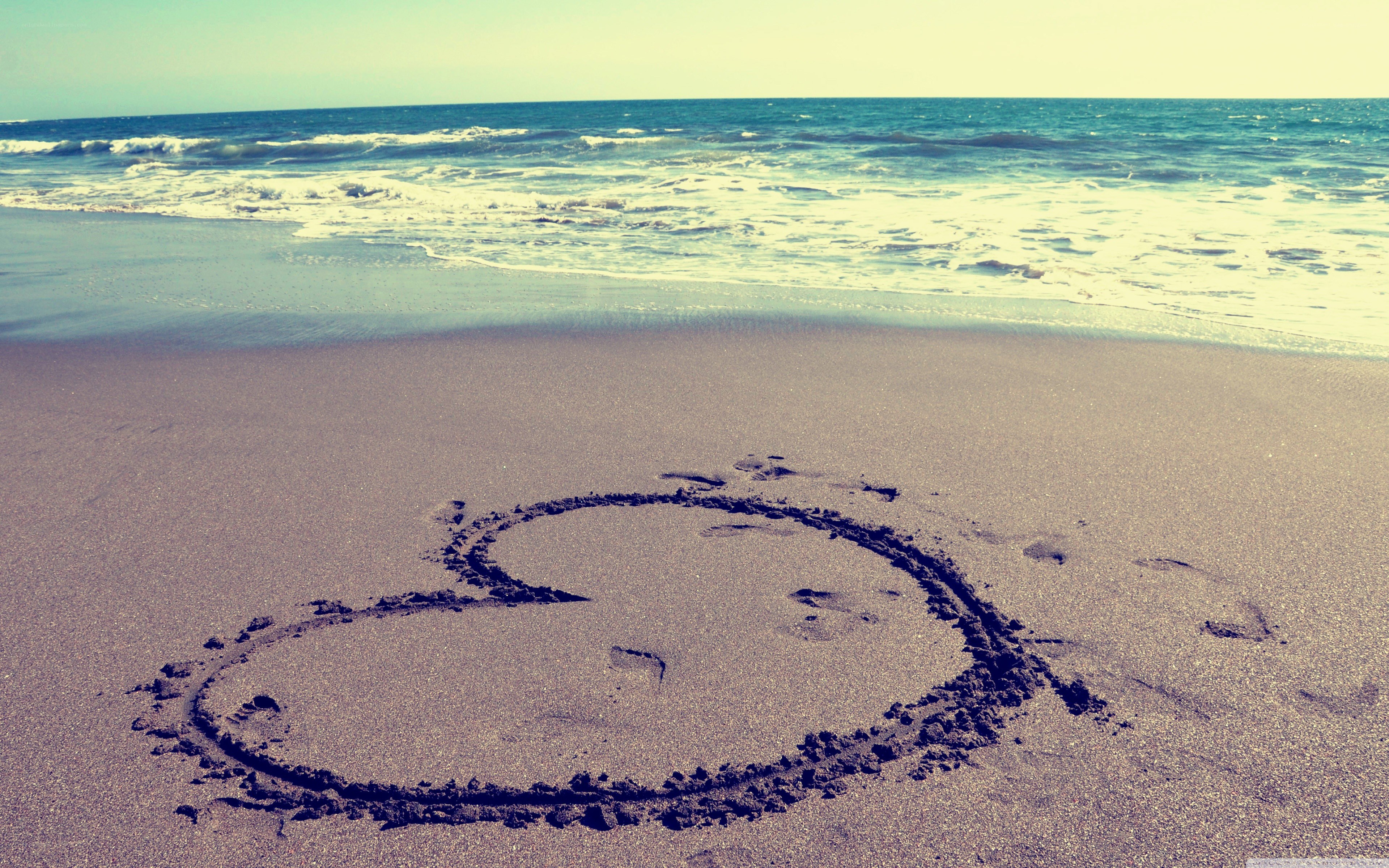heart drawn on beach sand