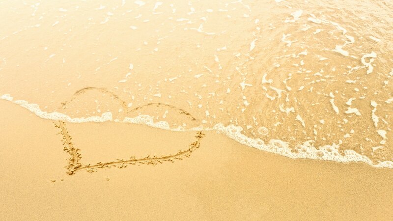 heart drawn on beach sand