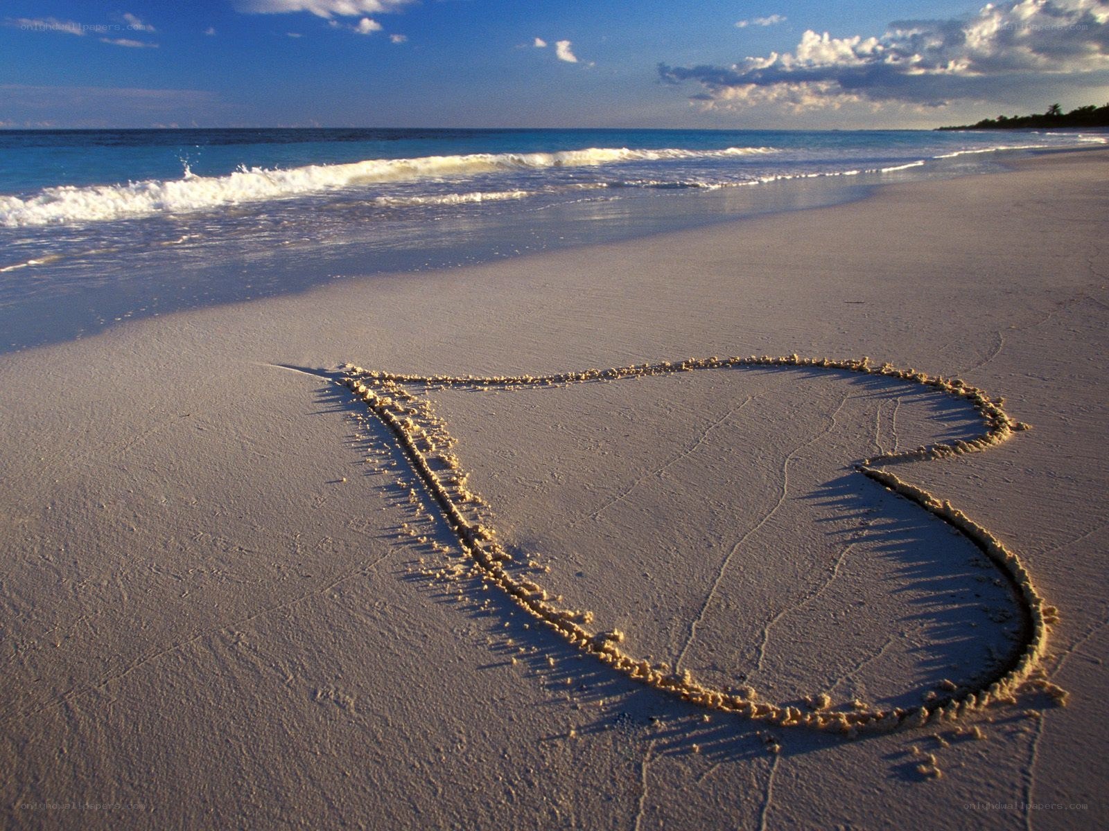Heart drawn on beach sand
