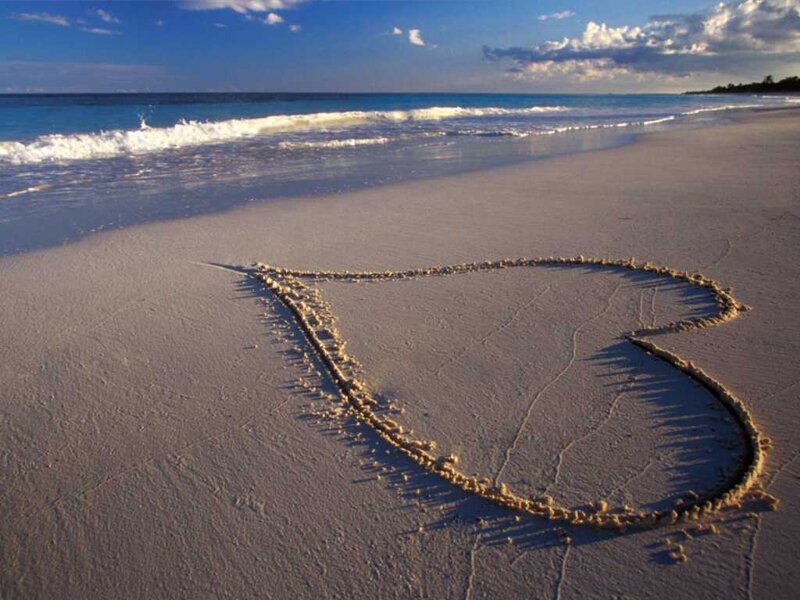 Heart drawn on beach sand