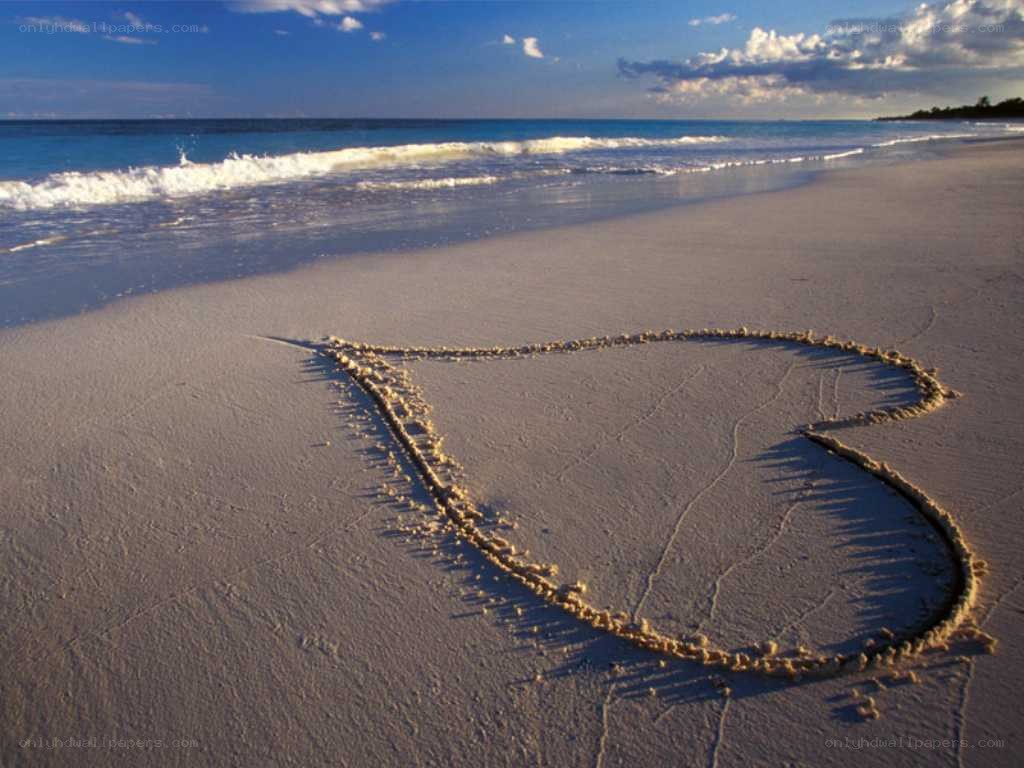 Heart drawn on beach sand