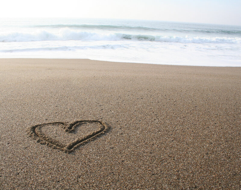 heart drawn on sandy beach