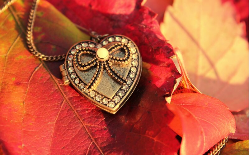 heart locket on autumn leaves