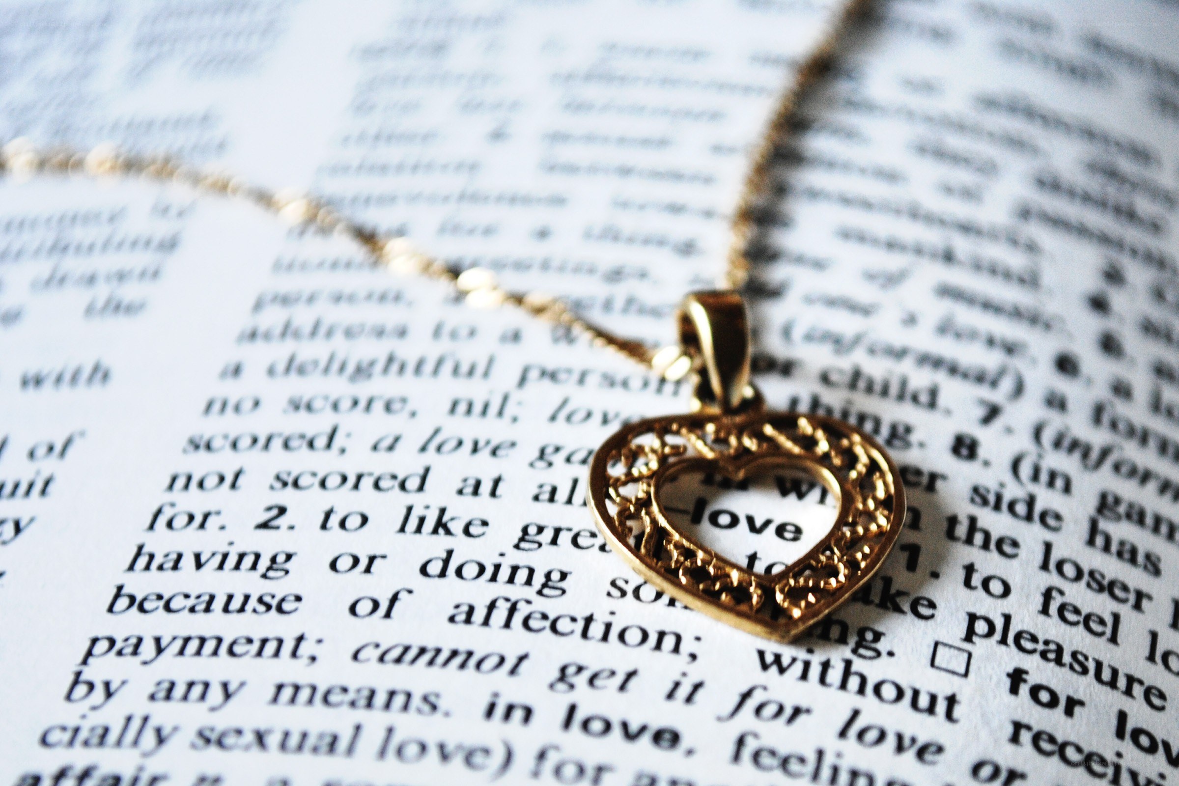 heart pendant on dictionary page