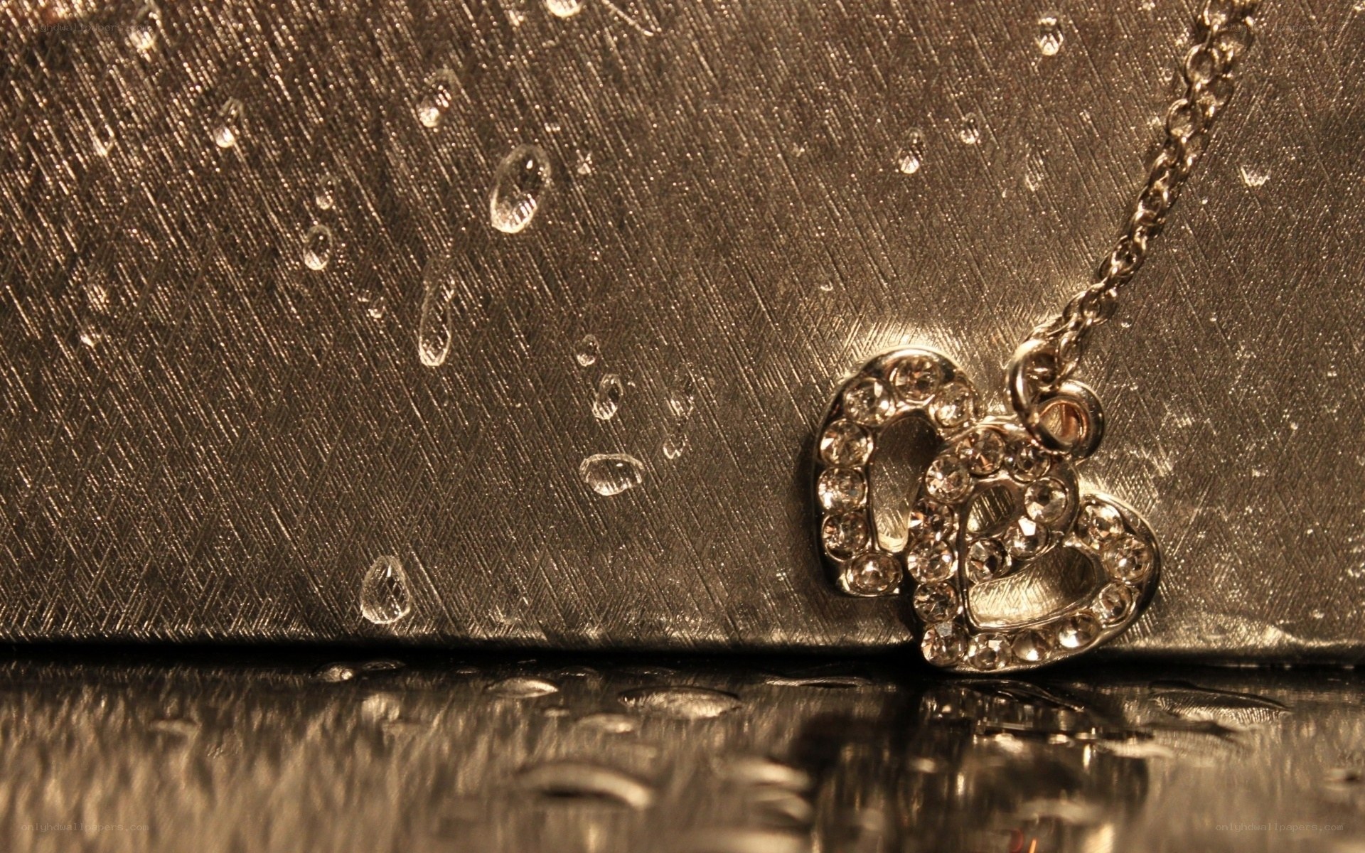 Heart pendant on wet surface