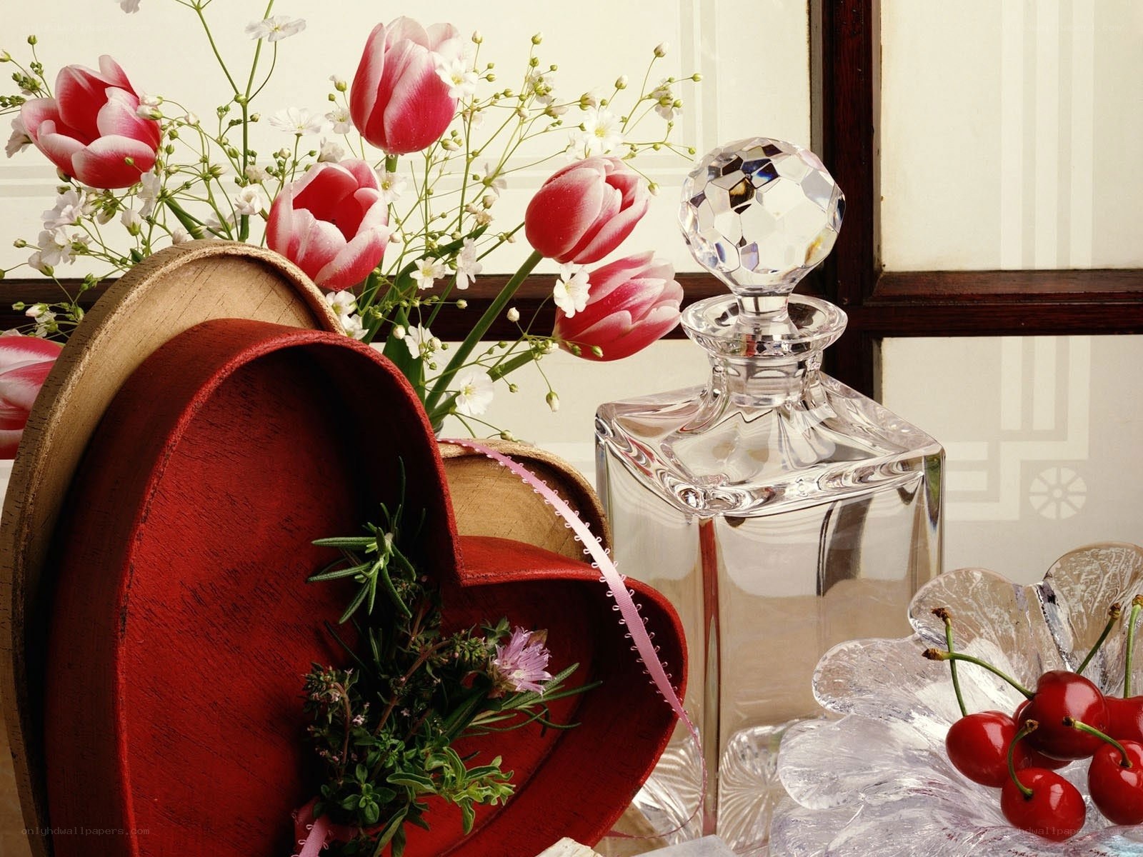 Heart-shaped box with flowers and perfume