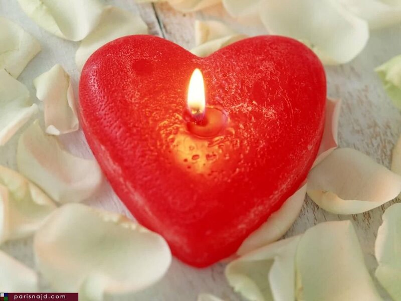 heart-shaped candle with rose petals