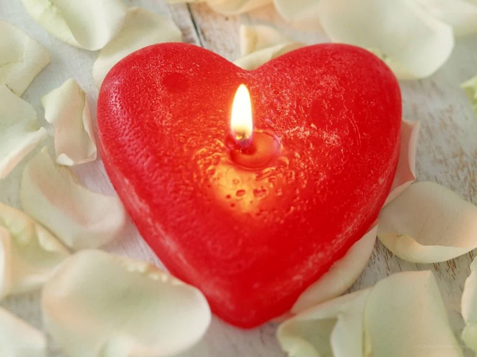 heart-shaped candle with rose petals