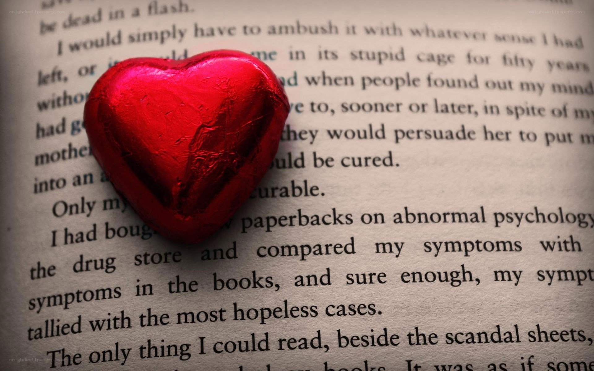 heart-shaped candy on book page