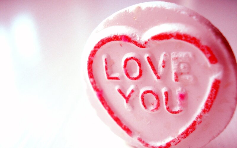 heart-shaped candy with 'love you'