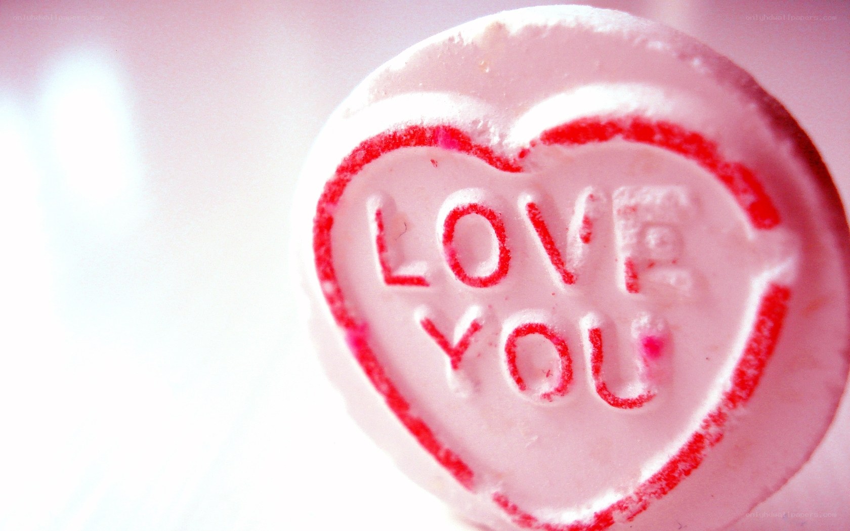 heart-shaped candy with 'love you'