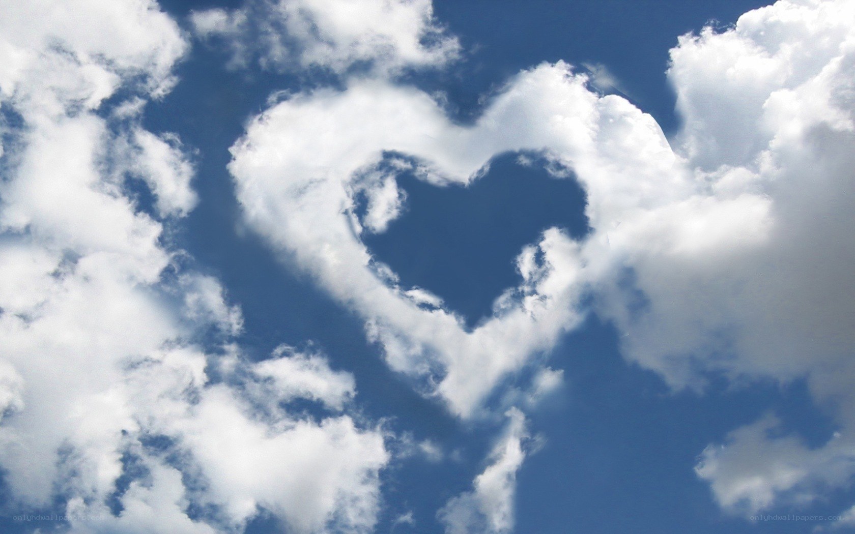 Heart-shaped cloud in blue sky