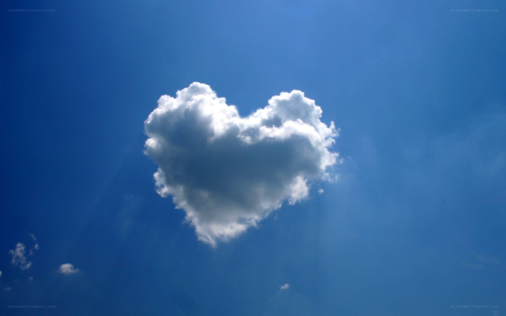 Heart-shaped cloud in blue sky