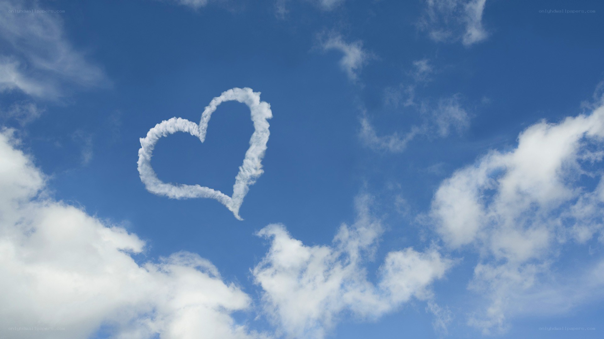 heart-shaped cloud in blue sky