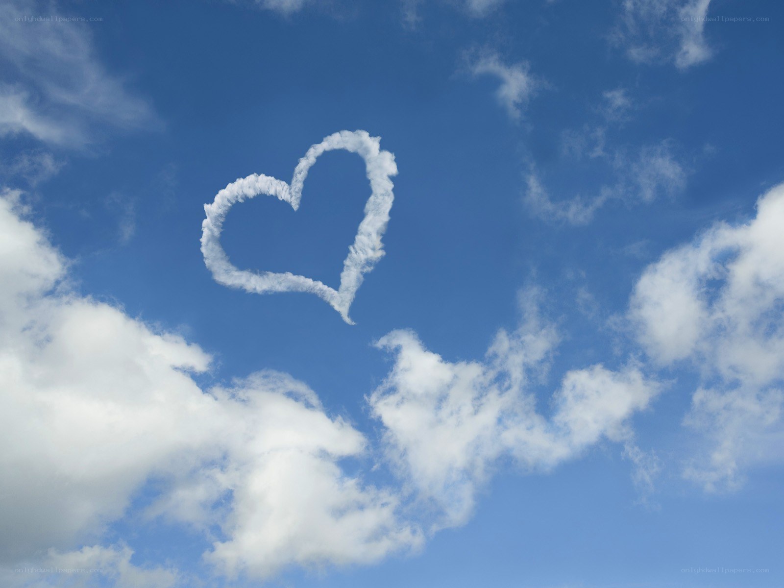 Heart-shaped cloud in blue sky