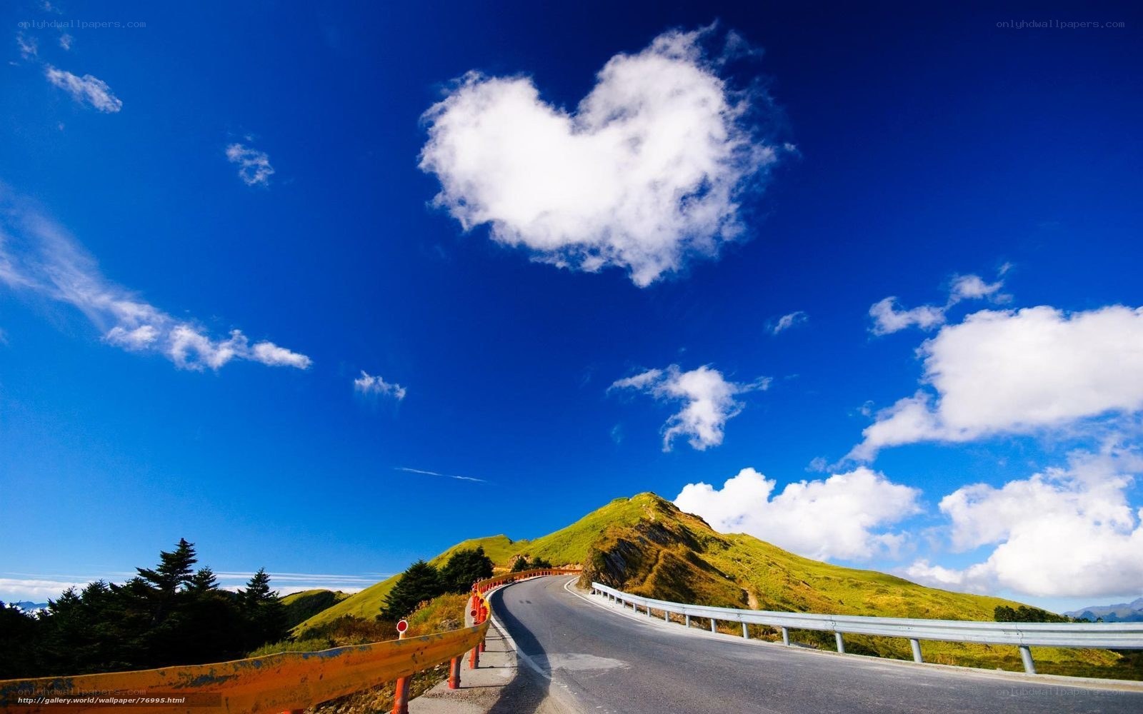 Heart-shaped cloud over mountain road