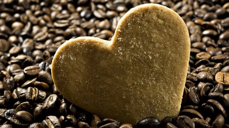 heart-shaped cookie on coffee beans