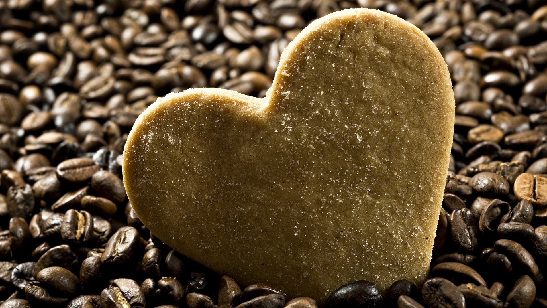 heart-shaped cookie on coffee beans