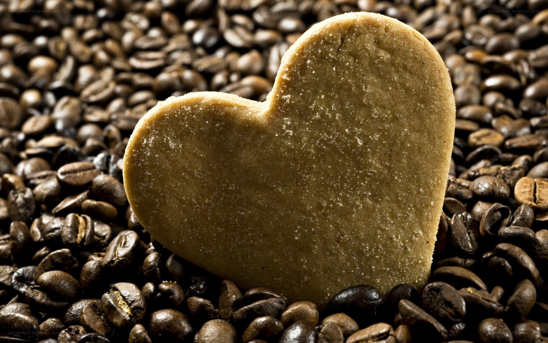 heart-shaped cookie on coffee beans