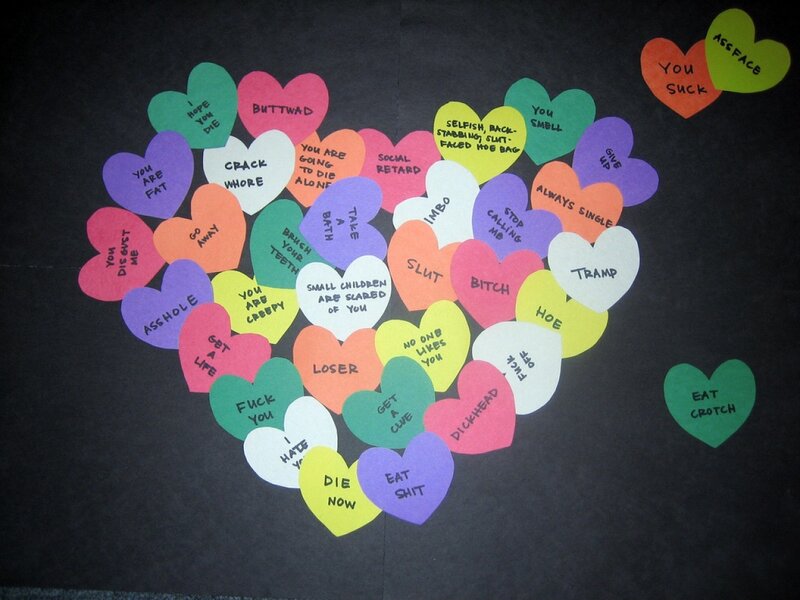 Heart-shaped insults on black paper