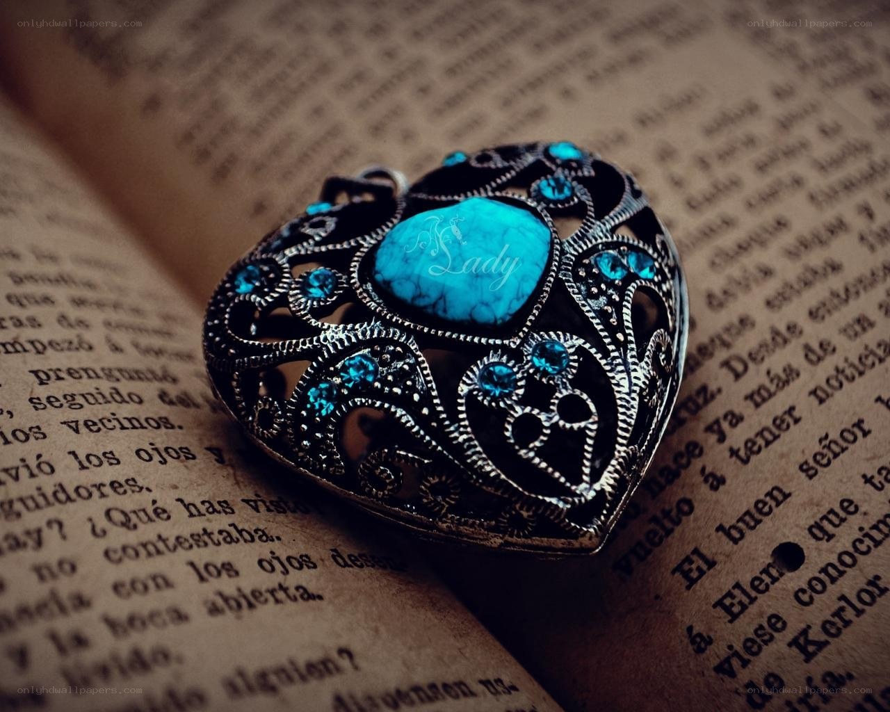 heart-shaped pendant on book