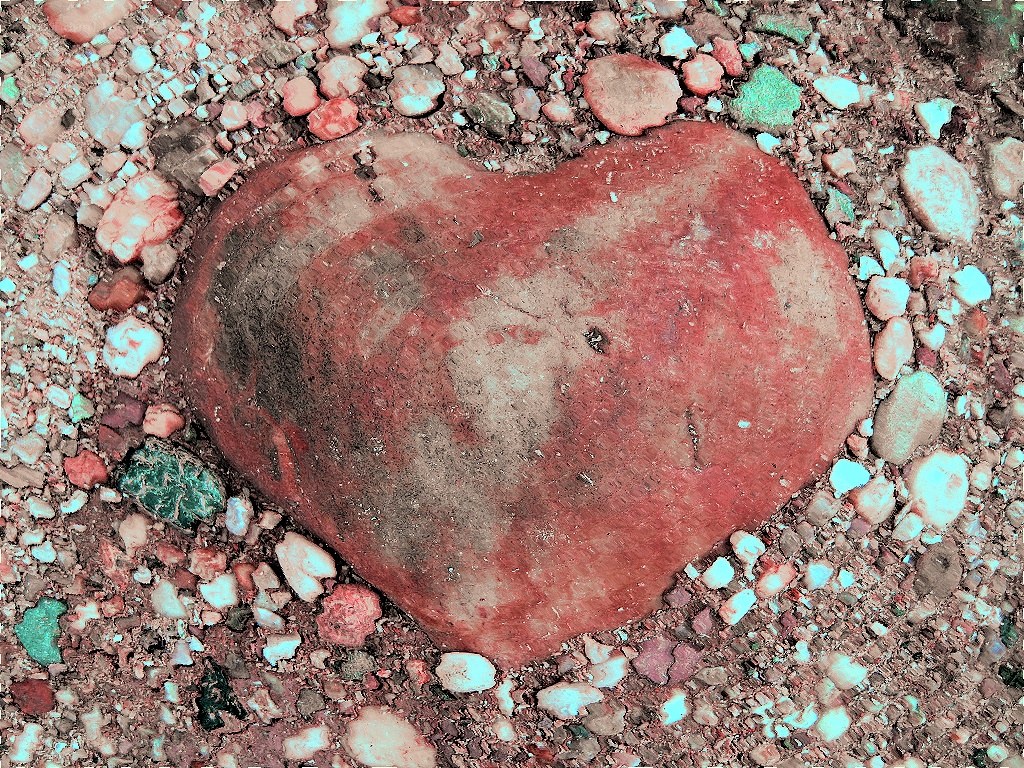heart-shaped rock on pebbles
