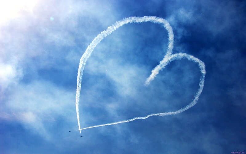Heart-shaped smoke trail in sky