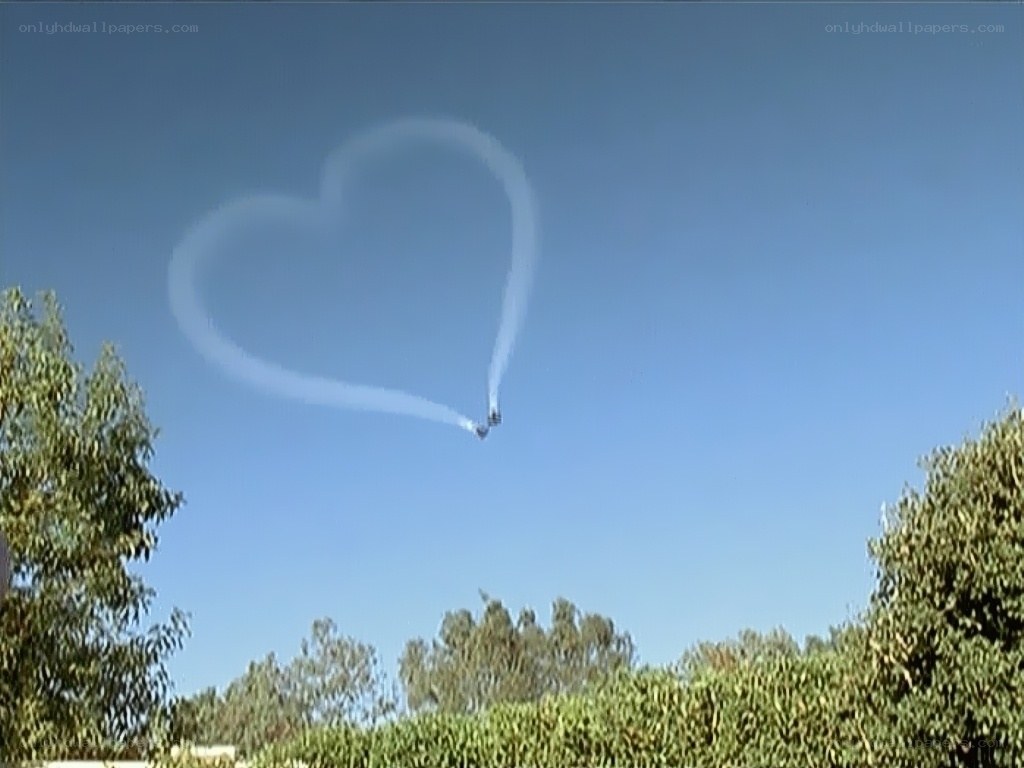 Heart-shaped smoke trail in sky