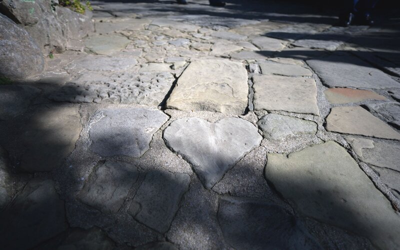 heart-shaped stone in cobblestone path
