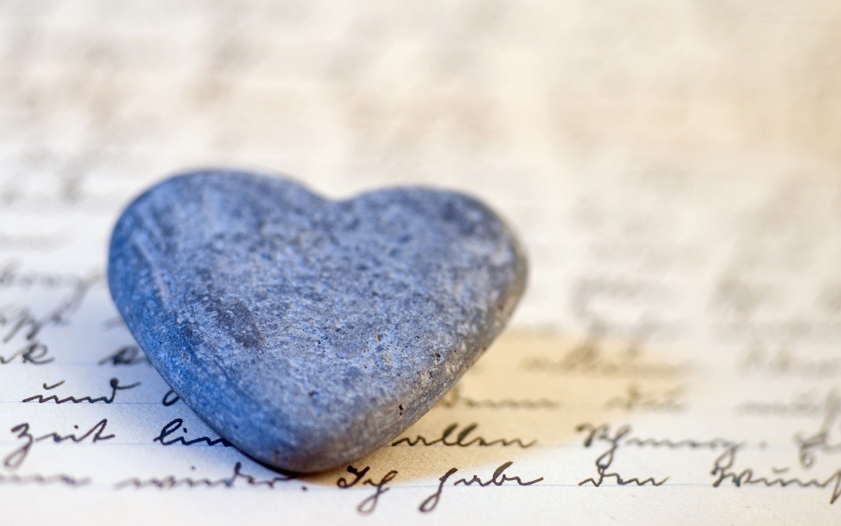 heart-shaped stone on letter