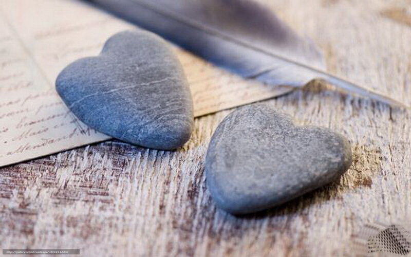 Heart-shaped stones on wood