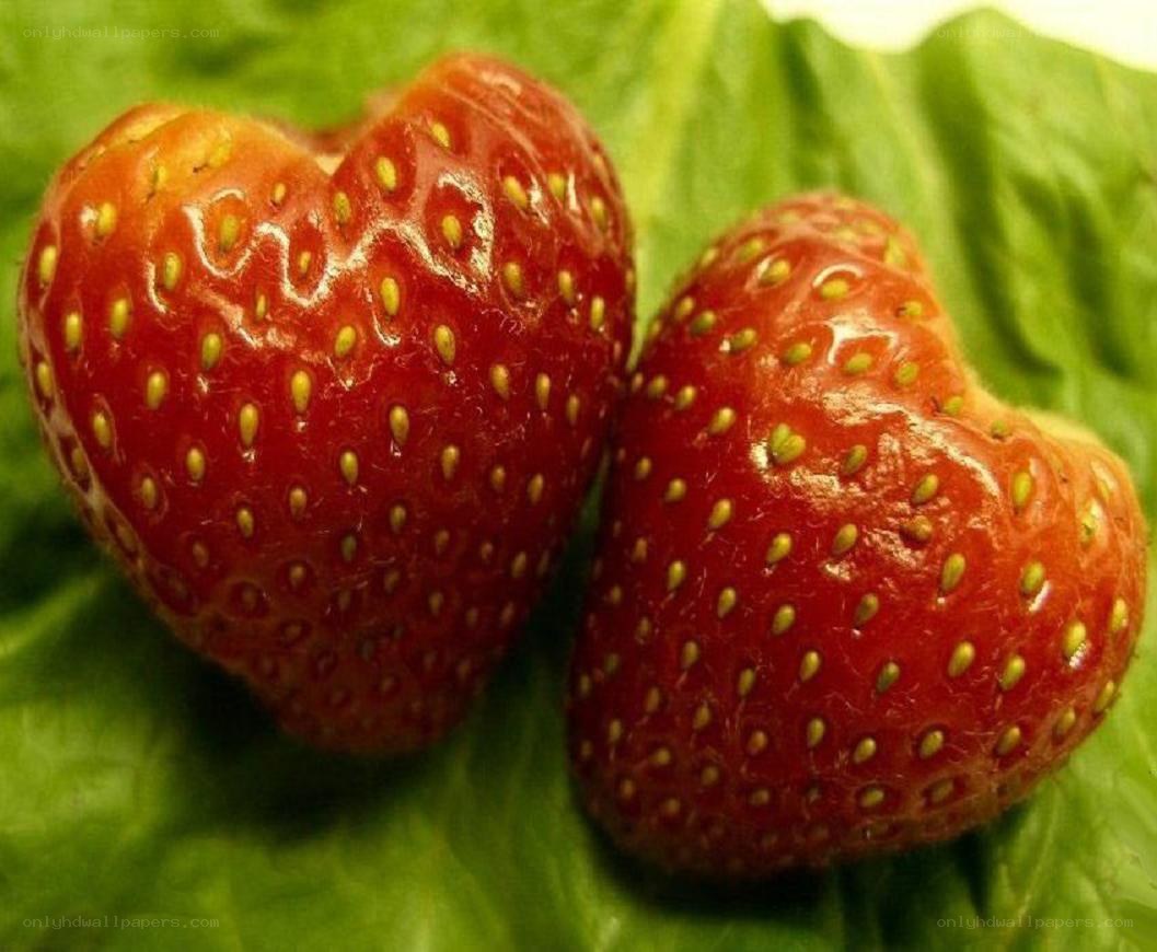 heart-shaped strawberries on leaf