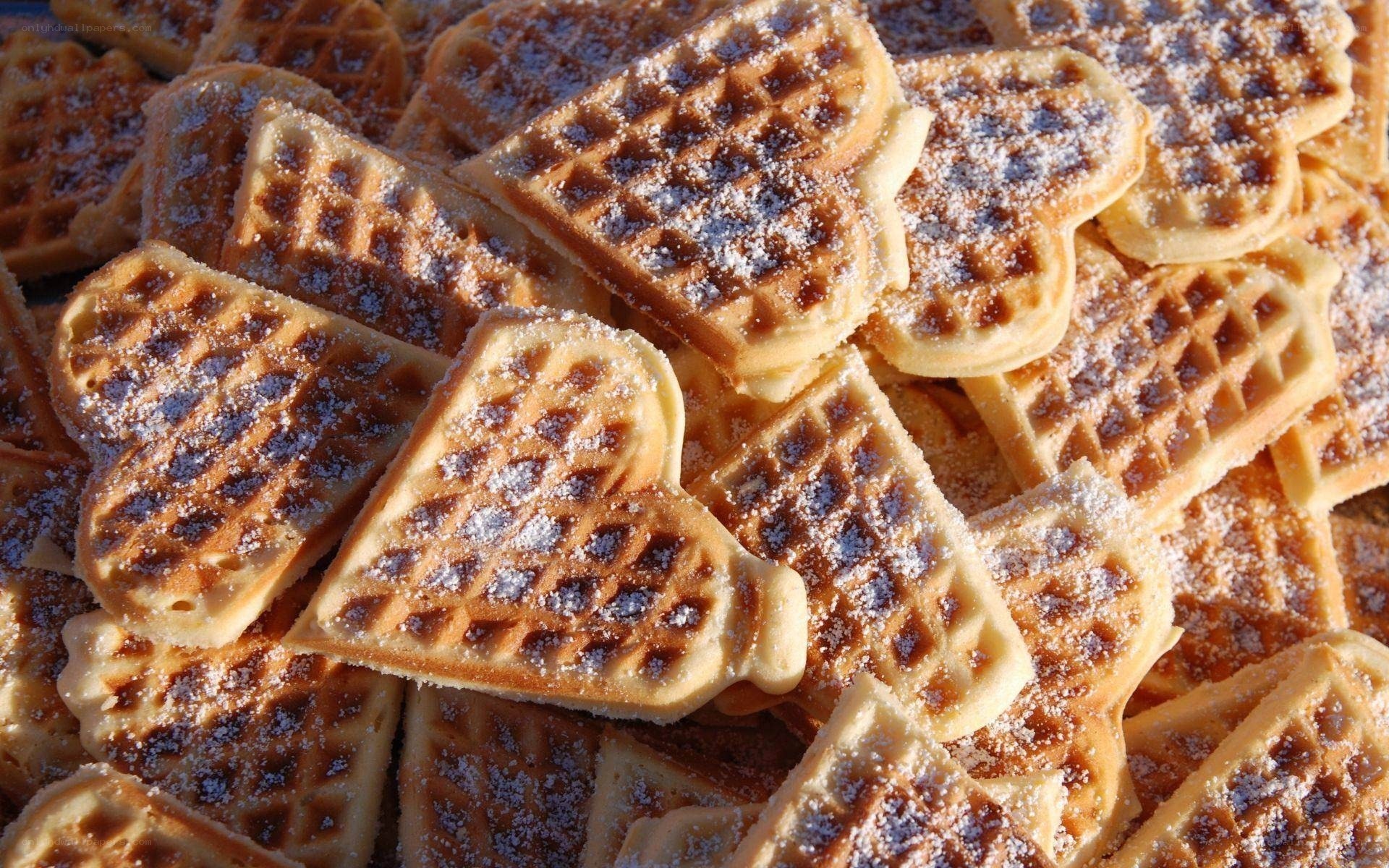 Heart-shaped waffles with powdered sugar