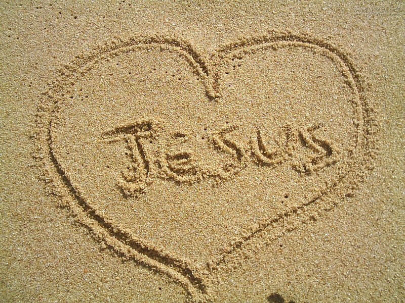 heart with jesus written in sand