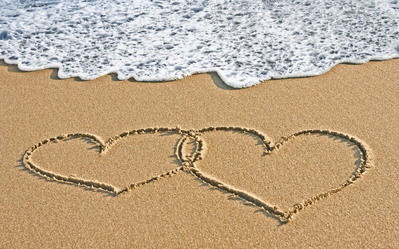 hearts drawn on beach sand