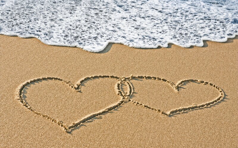hearts drawn on beach sand