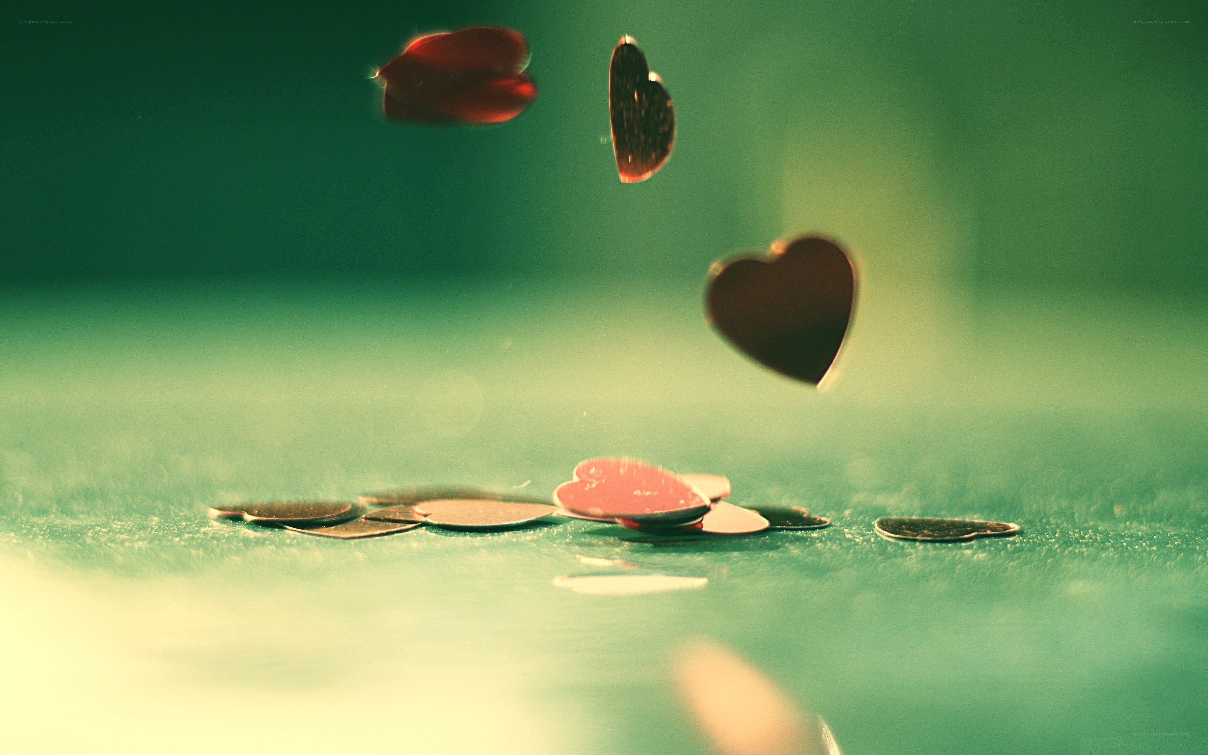Hearts falling on a green surface