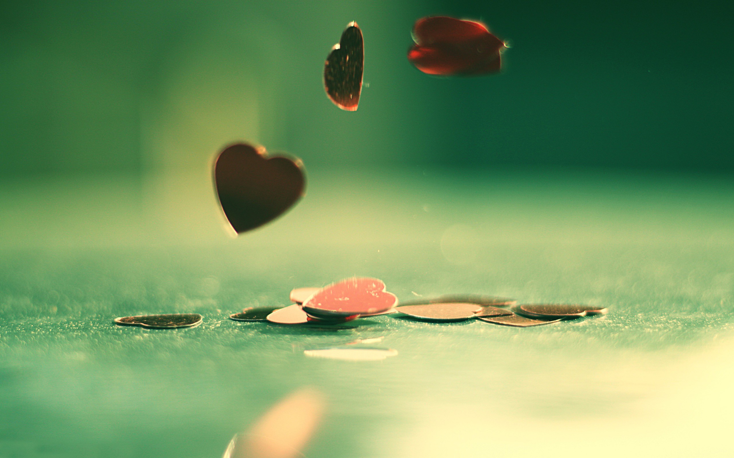 hearts falling on green surface