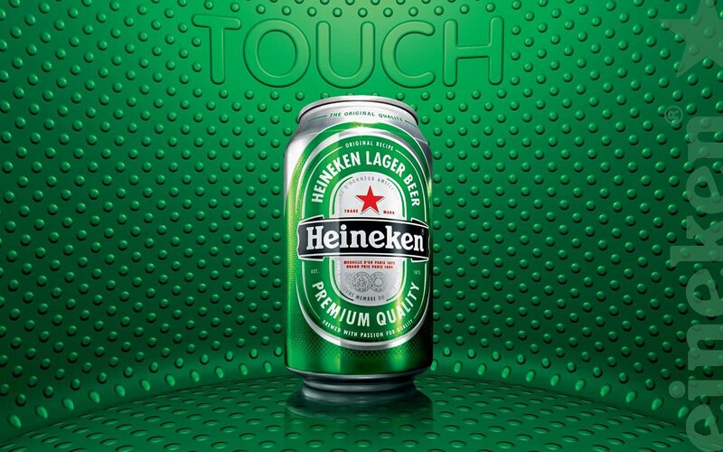 Heineken beer can on green background