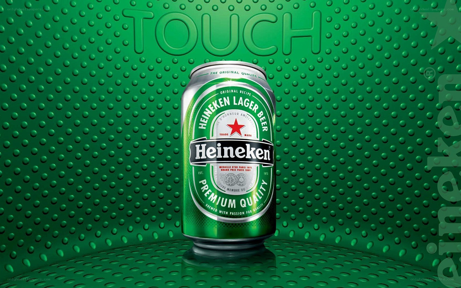 Heineken beer can on green background