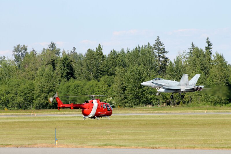 Helicopter and fighter jet on airfield