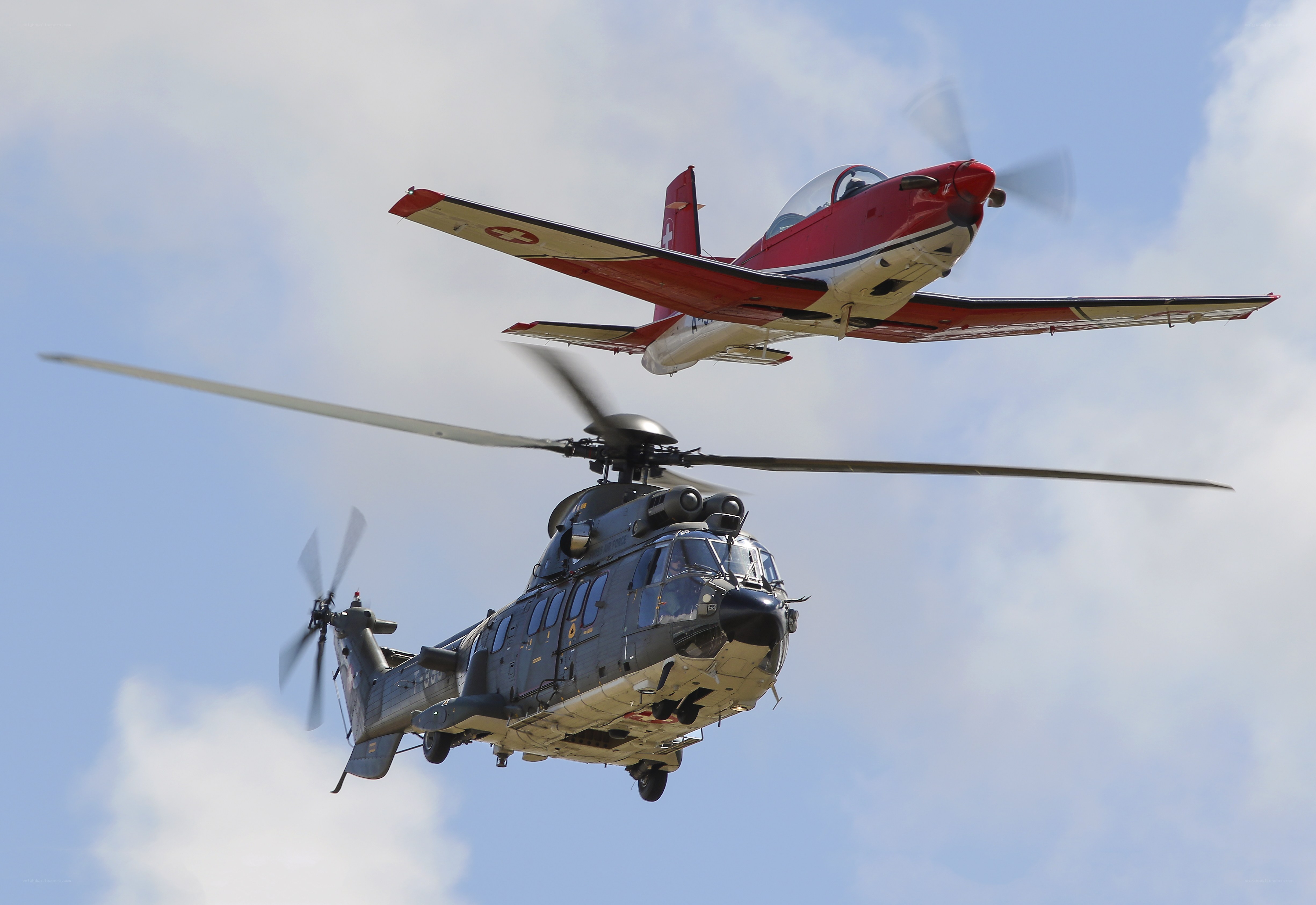 Helicopter and propeller plane in flight