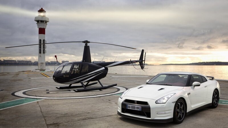 Helicopter and sports car at harbor